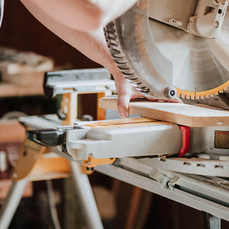 handyman cutting wood with disk saw handyman cutting wood with disk saw