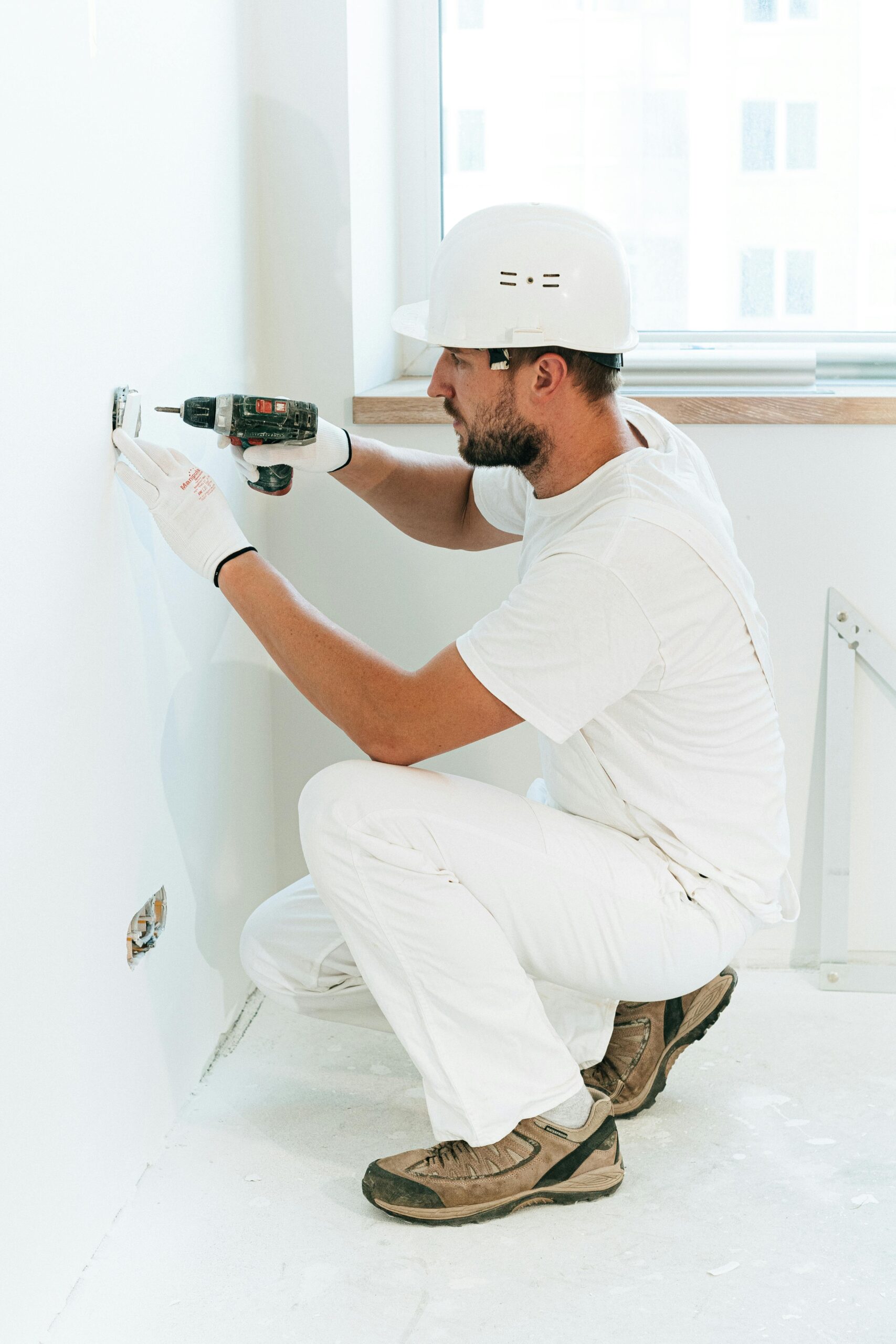handyman on wall socket